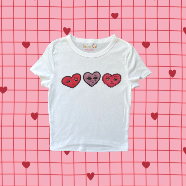 3 hand-drawn emotional hearts printed on a white baby tee